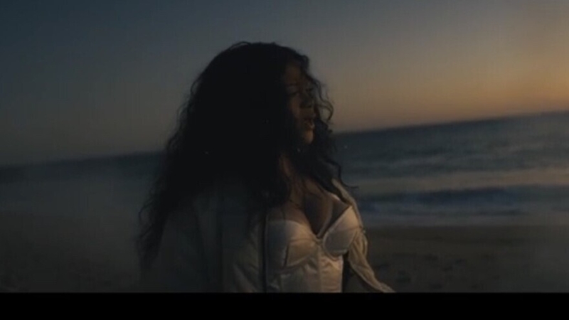 The emotional video sees shots of the singer on a beach