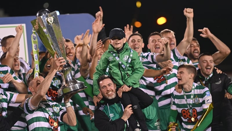 Shamrock Rovers captain Ronan Finn lifts the trophy as manager Stephen Bradley lifts his son Josh Bradley