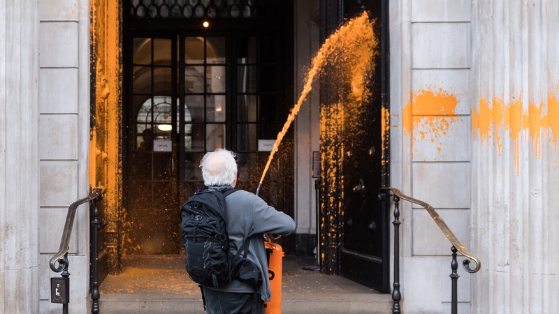 A Just Stop Oil supporter sprays paint onto Bank of England