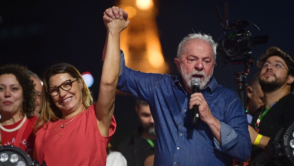 Luiz Inacio Lula da Silva holds the hand of his wife, Rosangela "Janja" da Silva, at a rally in Sao Paulo