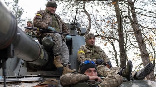 Ukrainian artillery unit members prepare to fire towards Kherson
