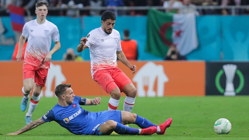 Alexandru Pantea (L) tackles West Ham's Divin Mubama (R) of West Ham