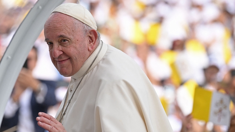 Pope Francis waves to the crowds from the 'popemobile'
