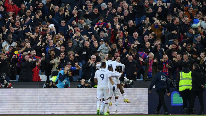 Michael Olise celebrates with the fans after scoring the winning goal