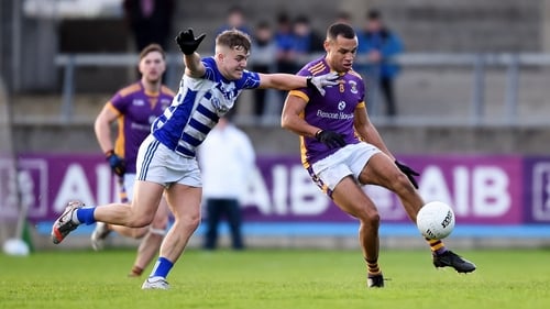 Craig Dias of Kilmacud Crokes gets his pass away despite the close attention of Tom Browne of Naas