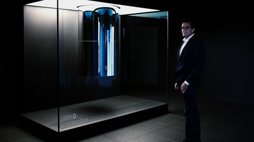 Dario Gil, Director of IBM Research, standing in front of IBM Q System One computer
