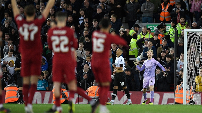Caoimhin Kelleher celebrates a penalty save from Derby County's Lewis Dobbin