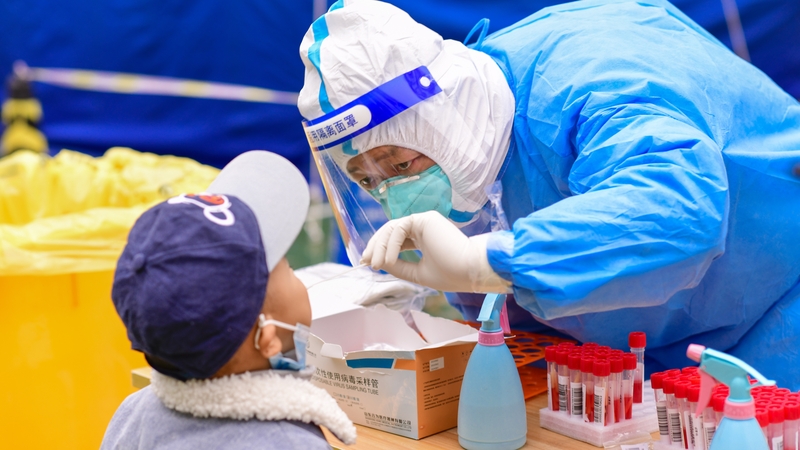 Medical workers conduct nucleic acid sampling for residents at a residential community in Hohhot