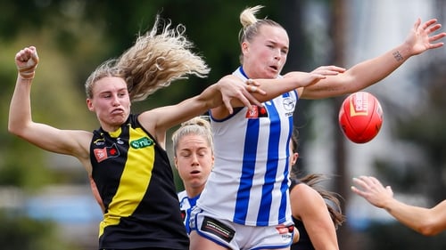 Vikki Wall of the Kangaroos holds off the Tigers' Beth Lynch