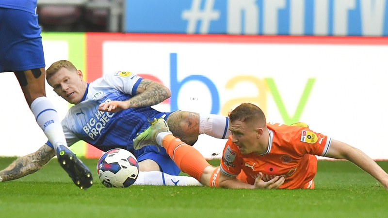 Blackpool's Shayne Lavery and Wigan's James McClean battle for the ball
