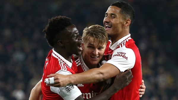 Odegaard (C) celebrates with Saka and Saliba