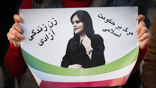 A poster of Mahsa Amini is held during a rally in Warsaw earlier this month