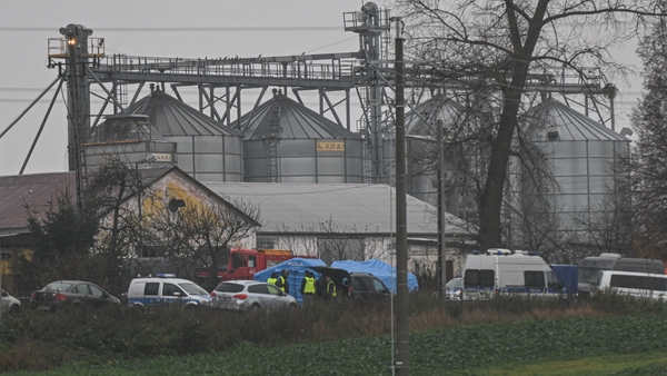 Police officers at the site of the explosion in the village of Przewodow