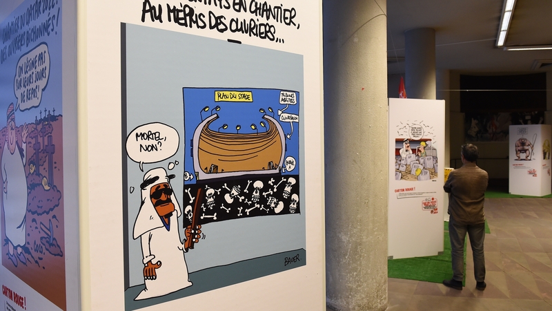A 2016 exhibition of cartoons entitled "Carton rouge a la FIFA" (A red card for FIFA) in France focusing on the exploitation of workers on construction sites of major international sporting competitions. Photo: Nicolas Tucat/AFP via Getty Images