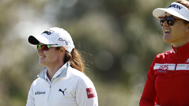 Leona Maguire of Ireland and (R) Hannah Green of Australia walk off the second tee box during the first round