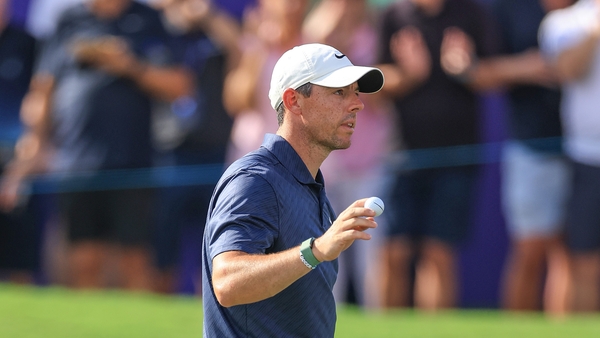 McIlroy acknowledges the crowds after making a putt for eagle on the 18th