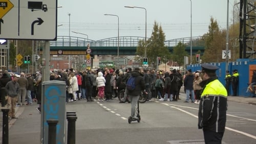 A group of between 200 and 300 people, many local residents, stopped traffic on the road during the protest