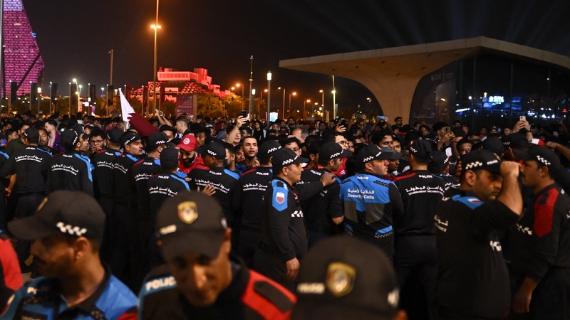 Police officers stand guard to prevent more people entering the Fan Festival at Al Bidda Park