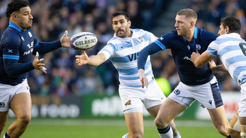 Finn Russell offloads to Sione Tuipulotu for his first try against Argentina