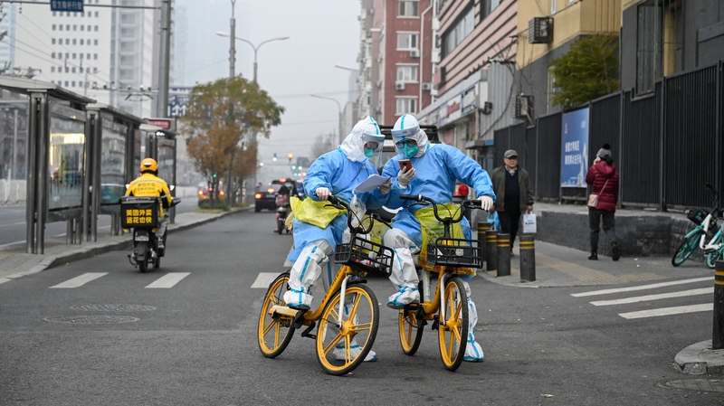 Health workers use bicycles to deliver testing swabs and tubes in Beijing