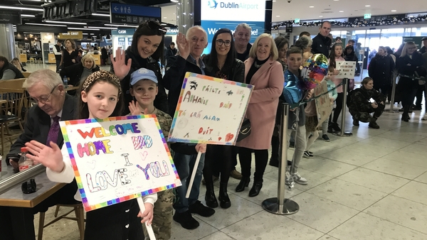 Adam and Erica Hickey wait for their dad to arrive at Dublin Airport