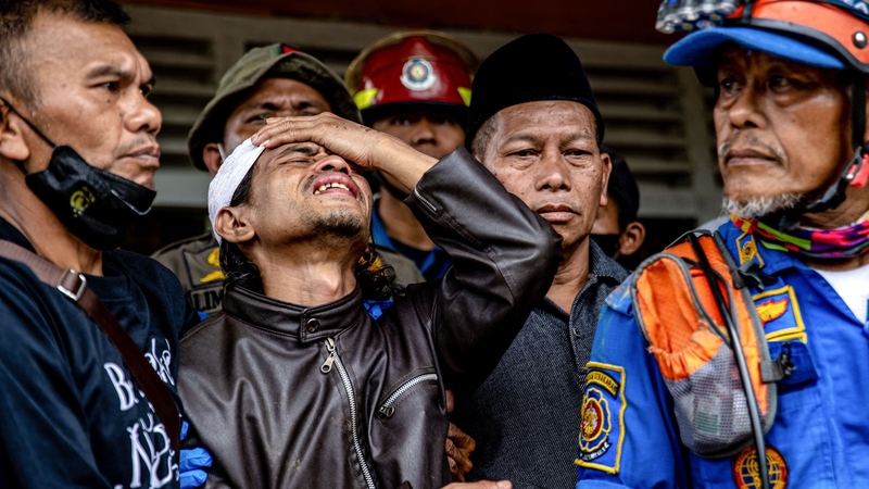 Ahmad Ashikin reacts after his daughter Cika is found dead in the rubble