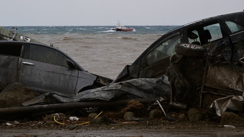 Damaged cars in the sea following heavy rains that sparked a landslide