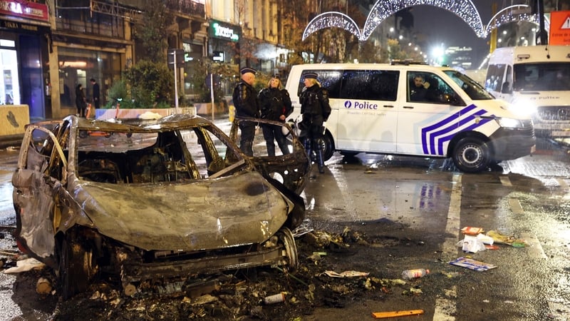 Dozens of fans smashed shop windows, threw fireworks and torched vehicles