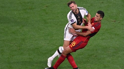 Nicolas Fullkrug and Rodri collide - both Germany and Spain looking to progress in Group E