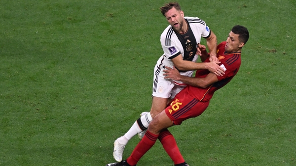 Nicolas Fullkrug and Rodri collide - both Germany and Spain looking to progress in Group E