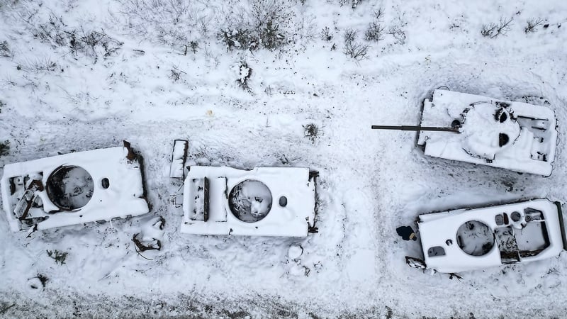 A man views destroyed Russian tanks outside Bucha this morning