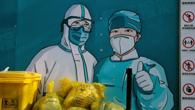 A mural of health workers in protective gear at a close Covid testing booth in Beijing, China