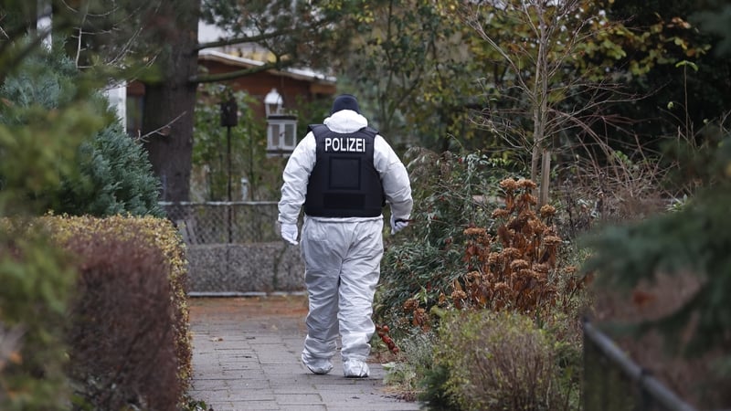 An officer works at the site of a raid in Berlin this morning