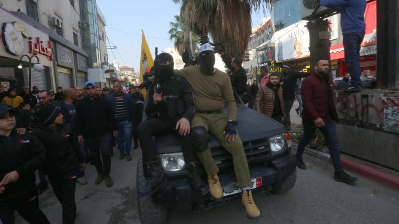 People attend the funerals of three of those killed in the West Bank today