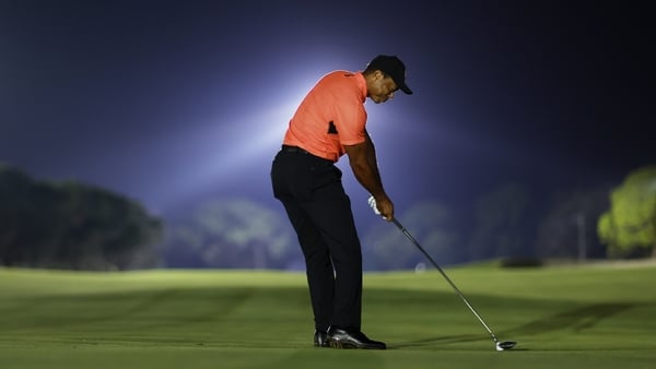 Woods hits his second shot to the seventh hole
