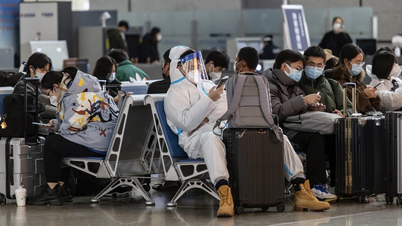 A traveller wearing protective gear at a train station in Shanghai, China