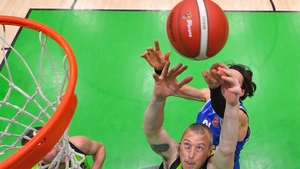 22 January: Kieran Donaghy of Garvey's Tralee Warriors claims a rebound ahead of Nil Sabata of Coughlan C&S Neptune during the Men's National Cup final at the National Basketball Arena