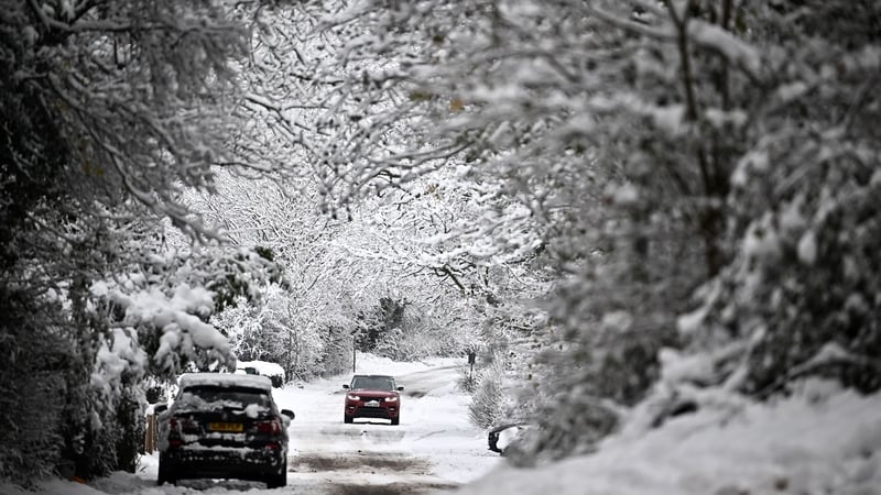 A car is driven along a snow-covered lane in Brenchley, southeast England