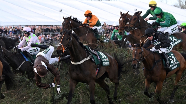 9 April: Jockey Harry Bannister falls from Domaine De L'Isle as they jump the The Chair fence in the Aintree Grand National, with eventual winner Noble Yeats just behind in the orange and black silks