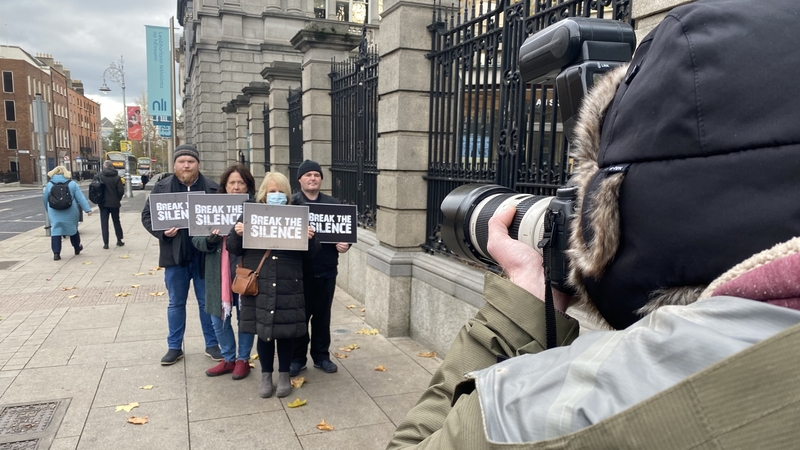 Survivors and supporters hold a protest outside Leinster House
