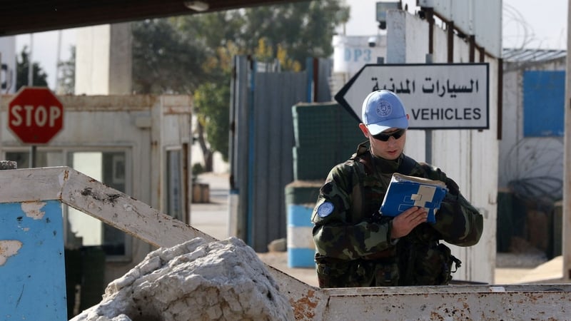 An Irish soldier from the United Nations Interim Force in Lebanon, stands guard at the entrance of his base