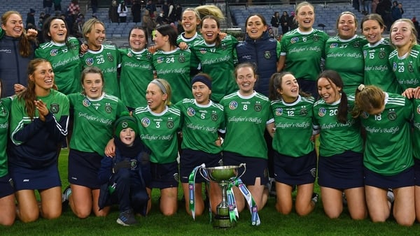 Sarsfields players celebrate with the trophy