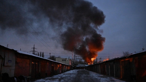 A fire is seen at a critical power infrastructure after a drone attack in Kyiv