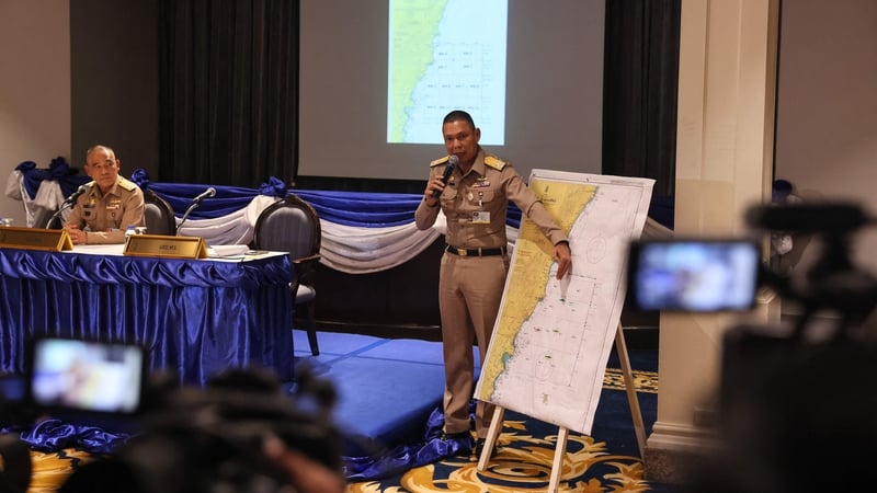 Royal Thai Navy Rear Admiral Chonlathis Navanugraha points to the search area on a map at a press conference in Bangkok