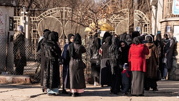 Groups of students gathered outside universities in Kabul, barred from entering by armed guards and shuttered gates