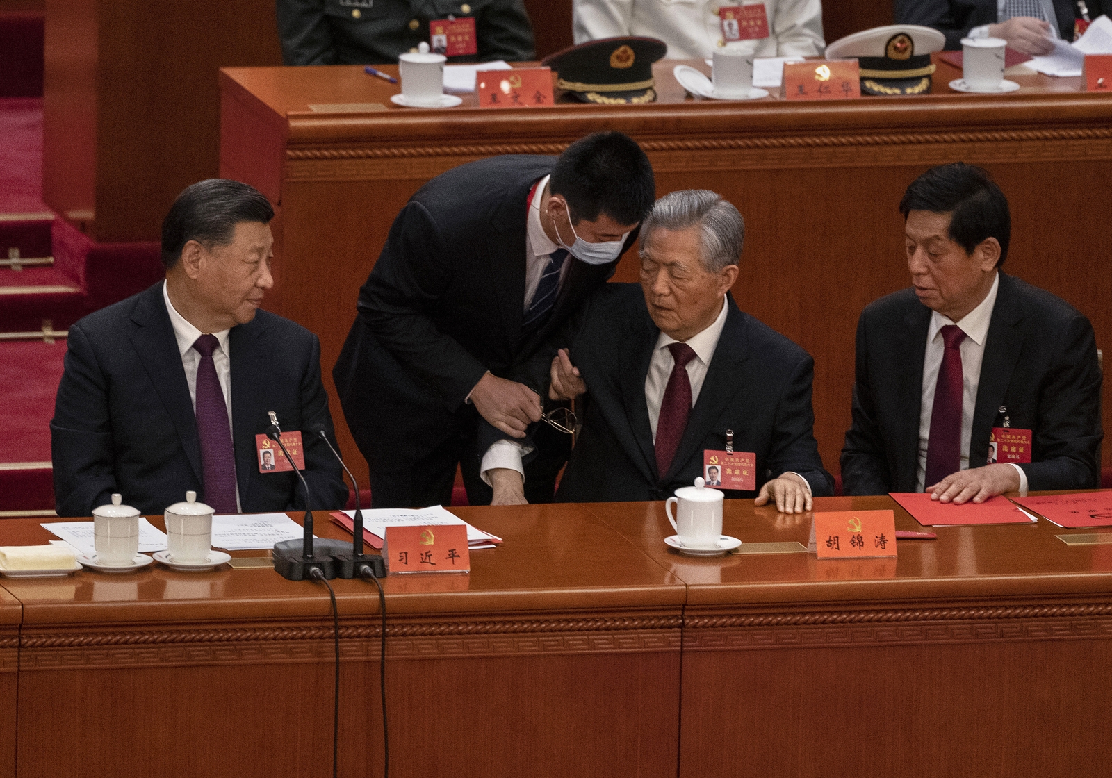 Hu Jintao escorted from the party conference (Kevin Frayer/Getty)
