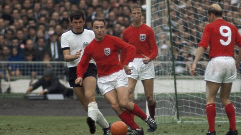 George Cohen in possession, watched by England's Jack and Bobby Charlton and West Germany's Lothar Emmerich in the 1966 World Cup final