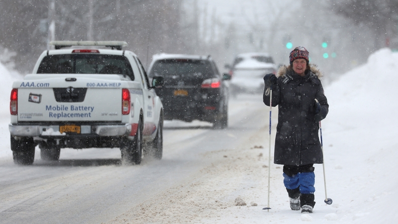 A woman walks through the snowy streets in Buffalo, new York, today
