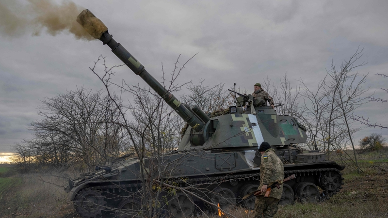 Ukrainian artillery unit members fire towards Kherson
