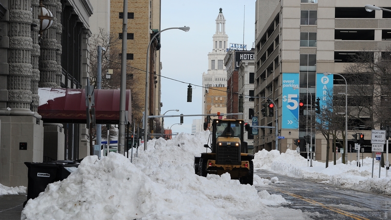 A loader clears piles of snow along Washington Street in Buffalo, New York